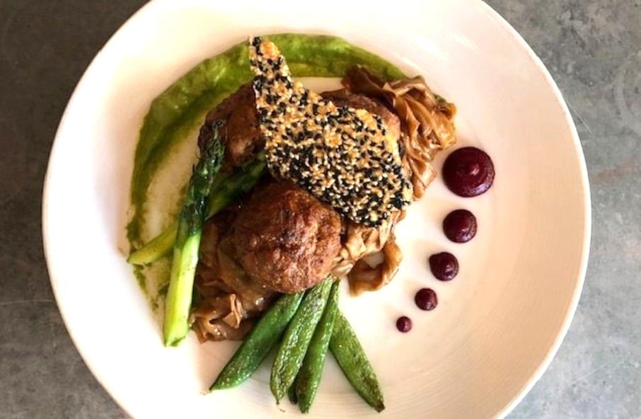 Veal & shiitake meatballs: black garlic noodles, charred scallion miso purée, beet ginger sauce, asparagus, snap peas, honey sesame crisp